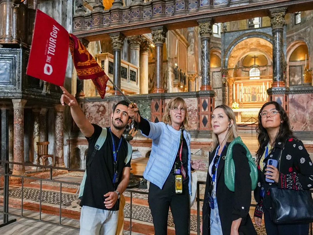 A group of tourists inside St. Mark's Basilica with a guide from The Tour Guy.