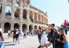 A group of tourists in front of the Colosseum with their guide from The Tour Guy.