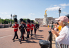 A man standing in front of Buckingham Palace with his guide from The Tour Guy.