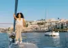 Guest standing at the bow of a boat with Porto skyline and Dom Luís I Bridge