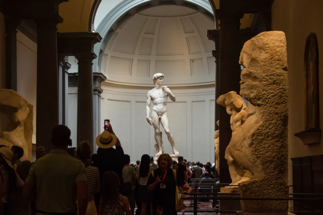 A group of tourists in front of the Statue of David inside of the Accademia Gallery while on tour with The Tour Guy.
