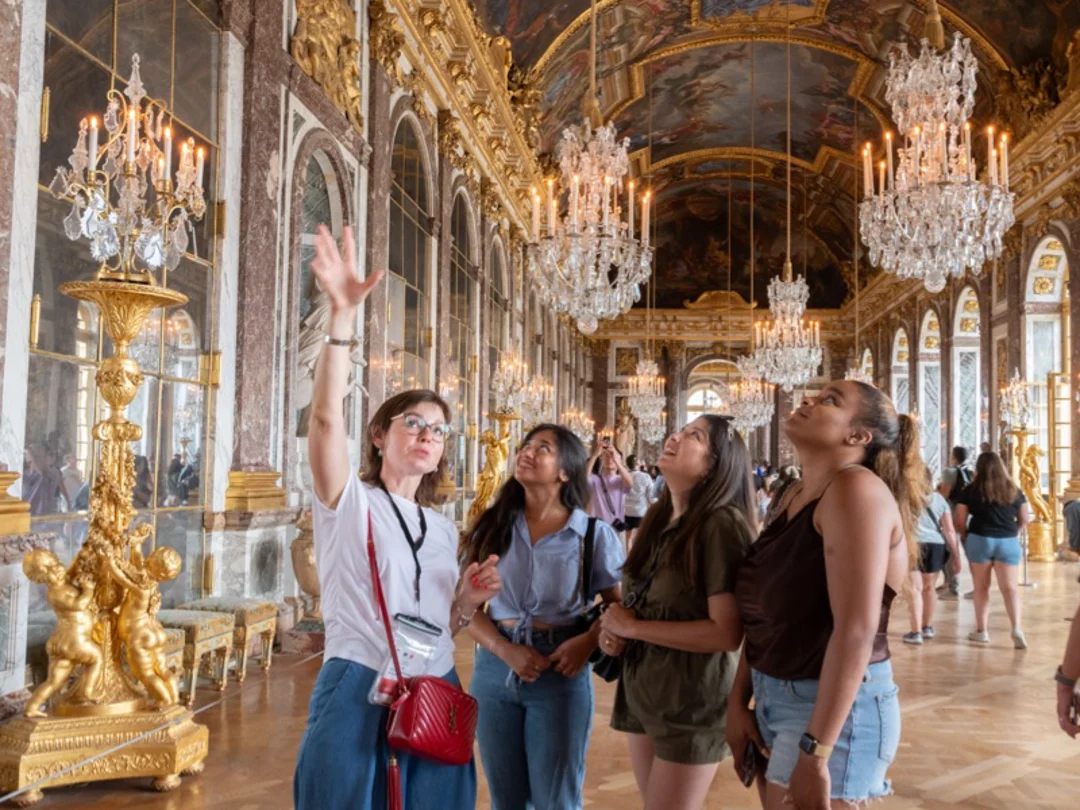 Customers on a tour at Versailles in the Hall of Mirrors with a guide from The Tour Guy.
