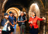 Wine maker showing tour group historic cellar