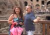A couple having their picture taken at the Colosseum.