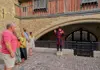 A Tower of London Beefeater speaking with a group of tourists on tour with The Tour Guy.