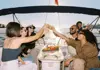 Small group relaxing on a private boat with drinks in Porto