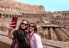 A pair of friends taking a selfie from the 2nd level of the Colosseum.