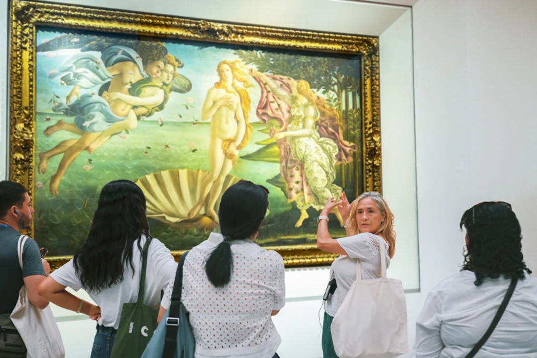 A group of tourists in front of the Venus of Urbino in the Uffizi Gallery while on tour with The Tour Guy.