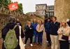 a guide explaining history facts about the Tower of London to a group of tourists