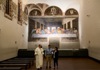 people standing in front of the last supper